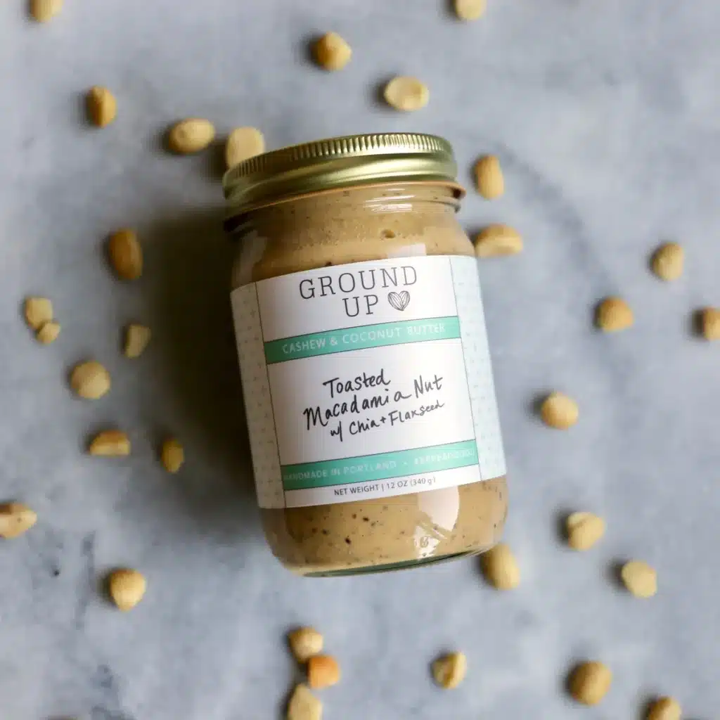 Jar of Ground Up toasted marshmallow and oat nut butter surrounded by oats