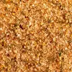 Close-up texture of a green and brown steak seasoning blend